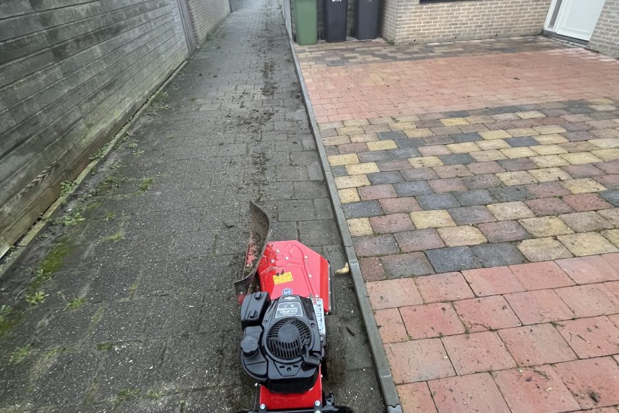 Onkruid verwijderen met borstelmachine op bestrating